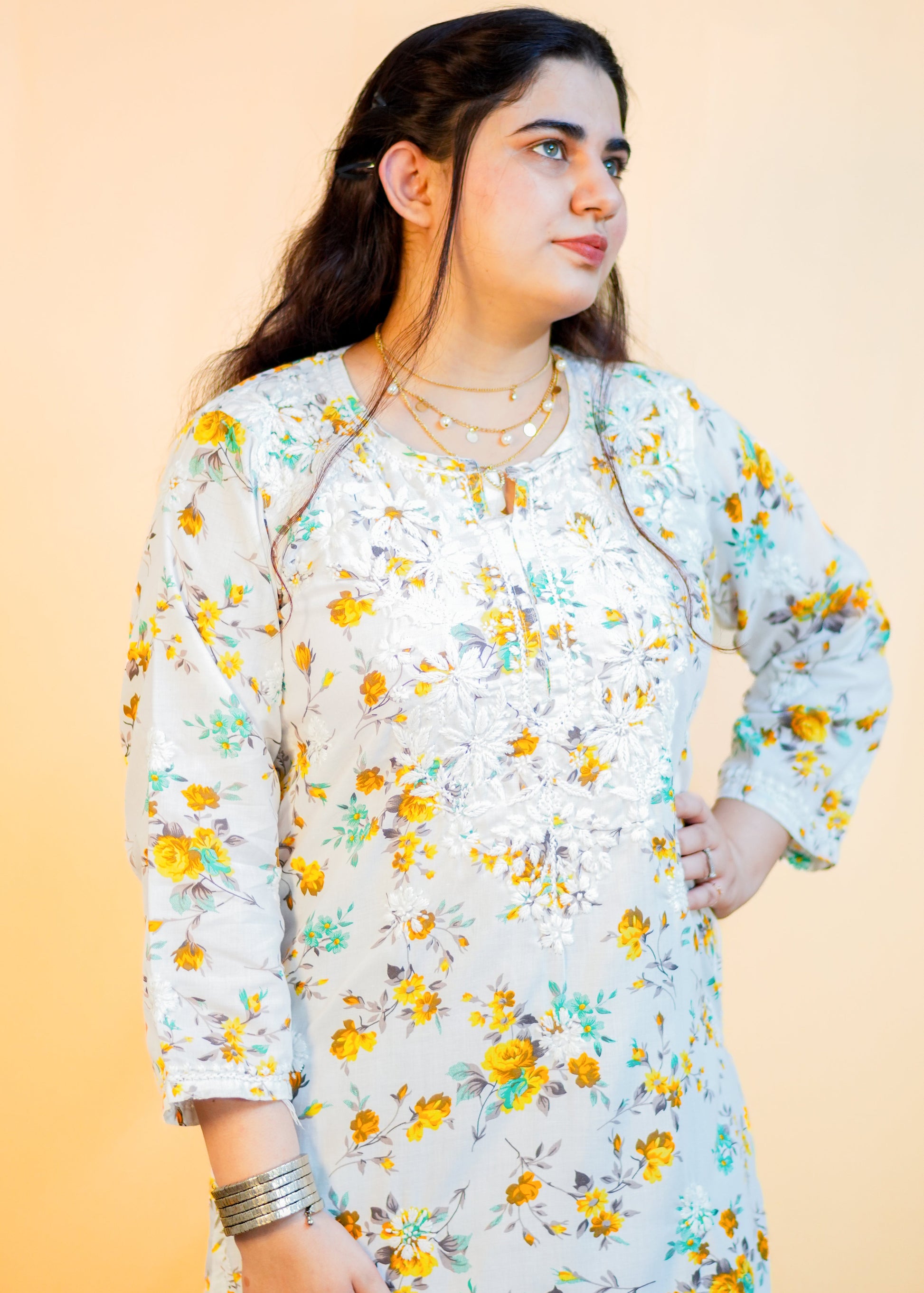 Woman wearing a floral dress with a plain background