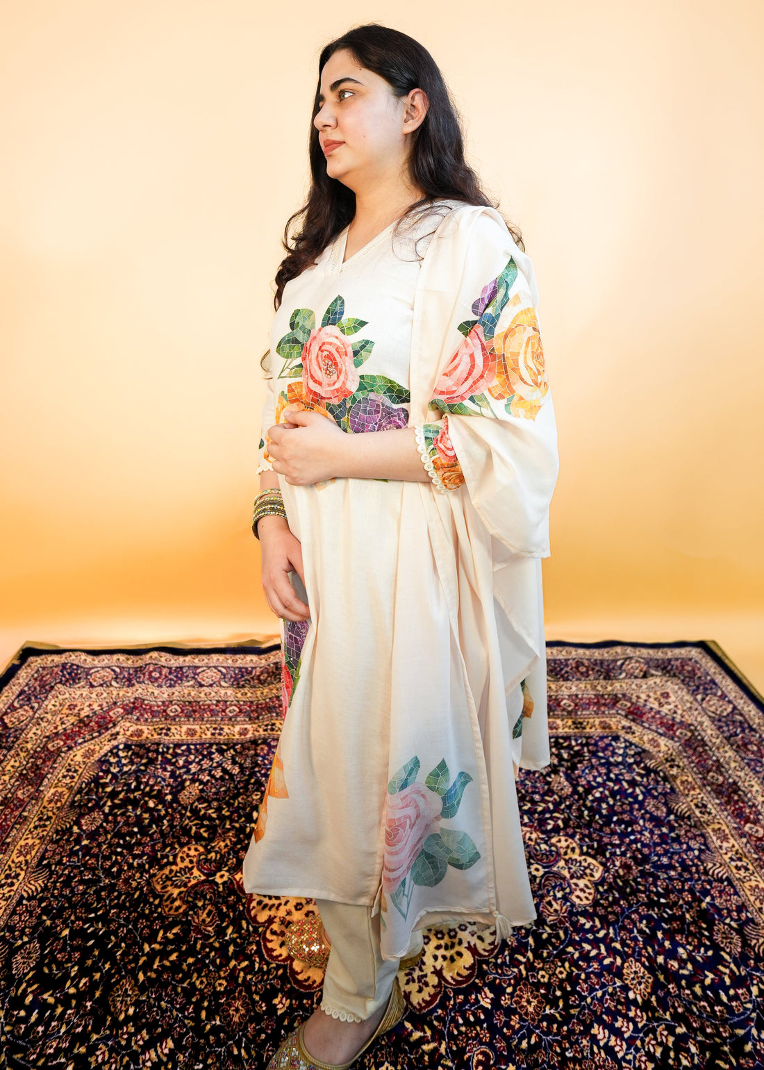 Woman wearing a white outfit with floral patterns on a yellow background