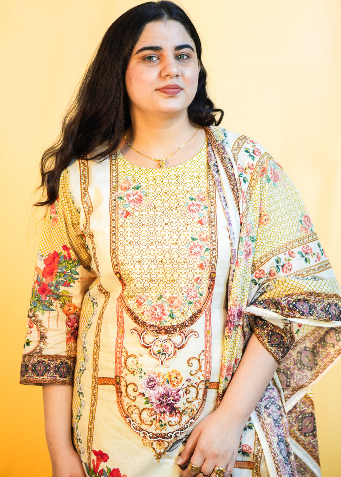 Woman wearing a colorful traditional outfit against a yellow background