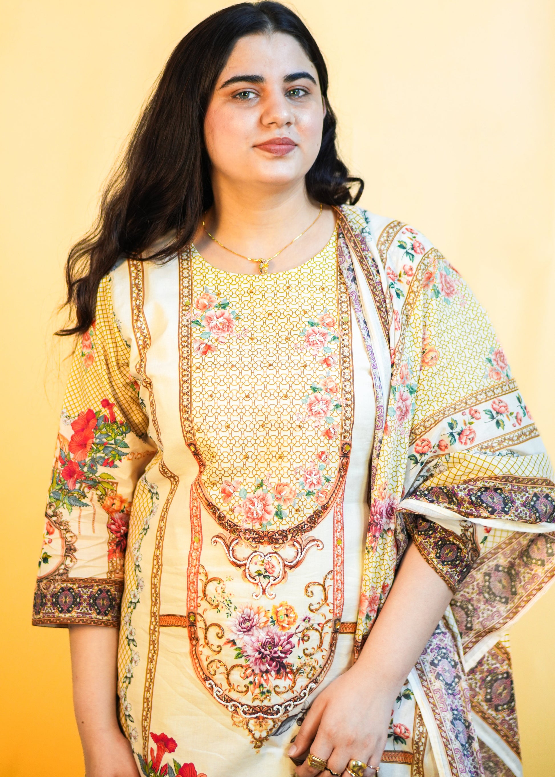 Woman wearing a colorful traditional outfit against a yellow background