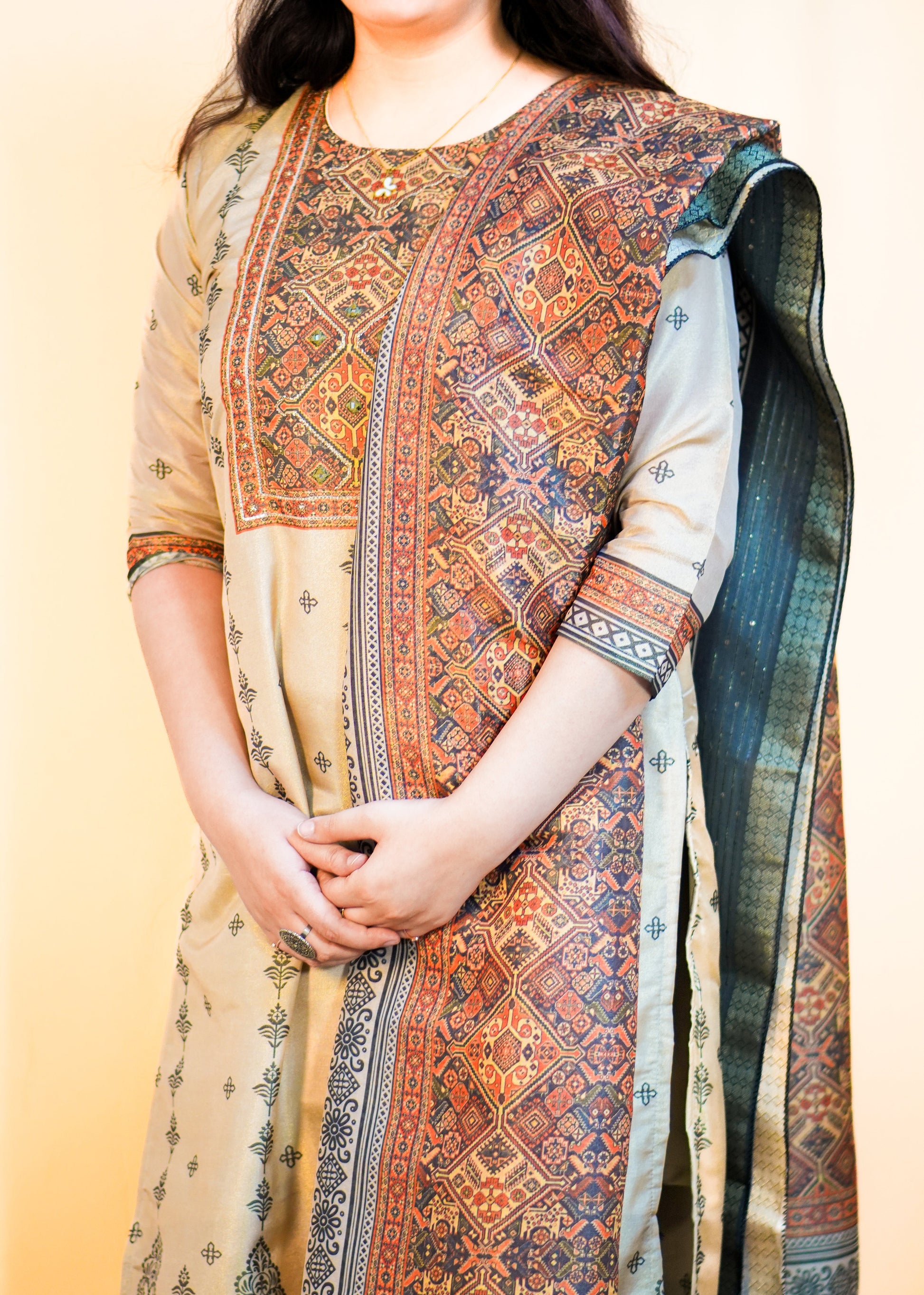 Traditional embroidered kurta with a matching dupatta on a plain background