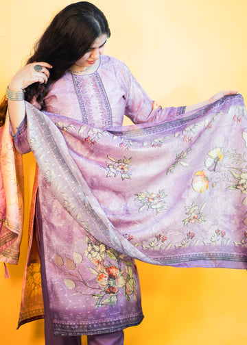 Woman holding a floral embroidered purple dupatta against a yellow background