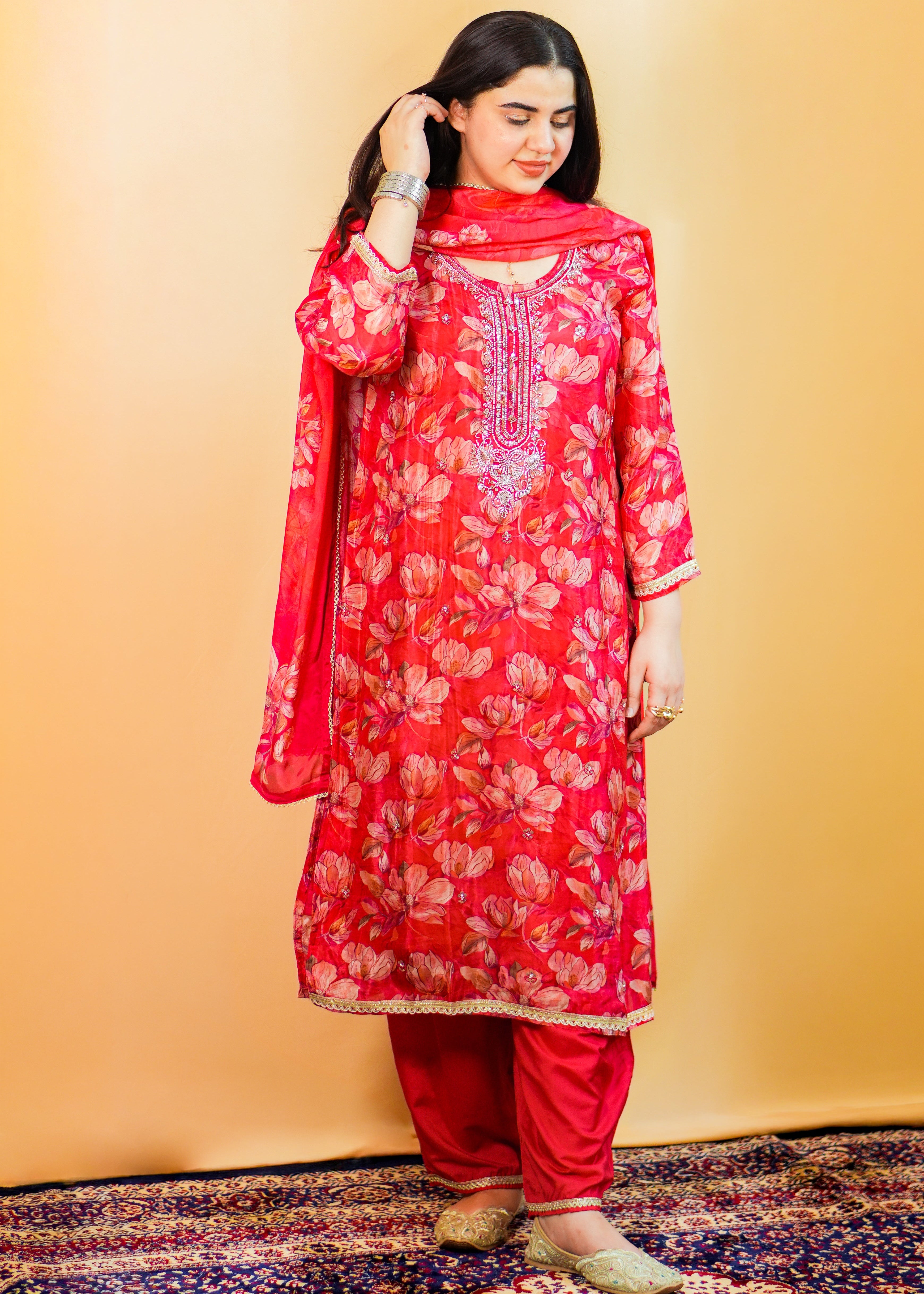 Woman wearing a red floral traditional outfit on a yellow background