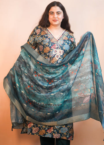Woman wearing a floral dress with a matching shawl on a beige background