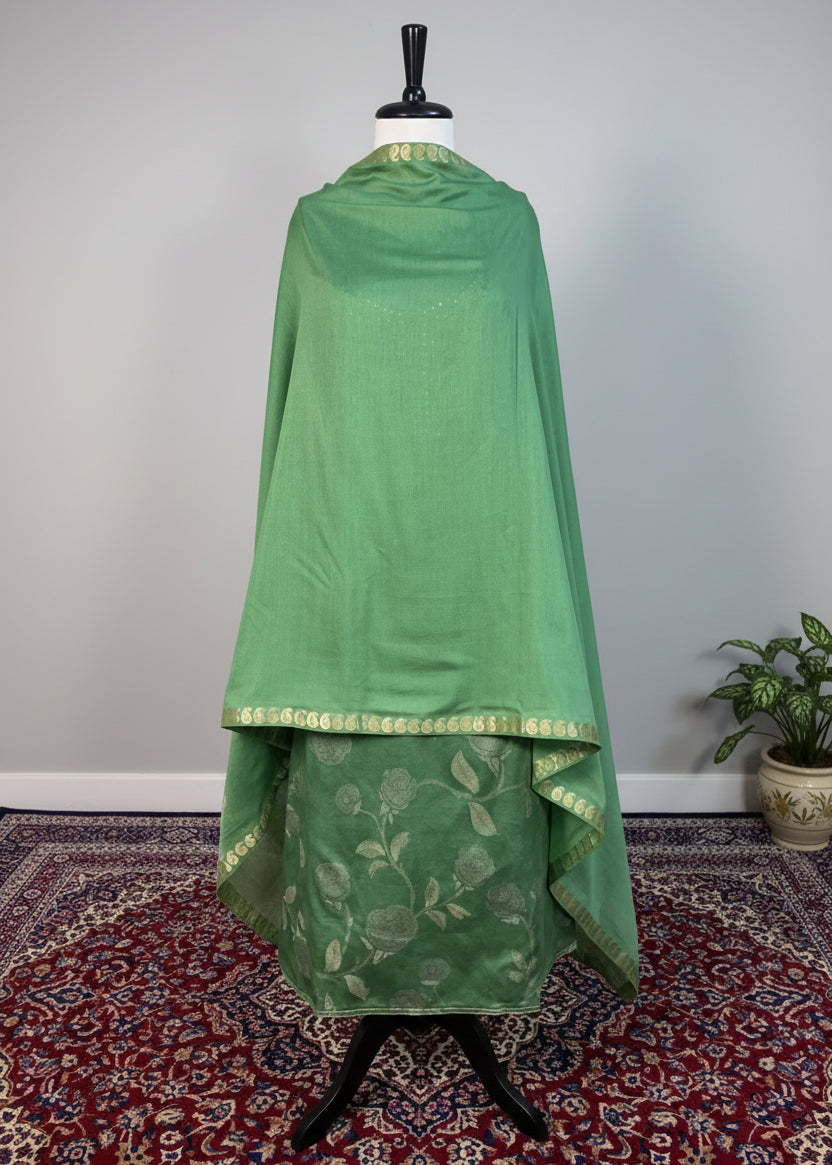 Green traditional outfit on a mannequin against a white background