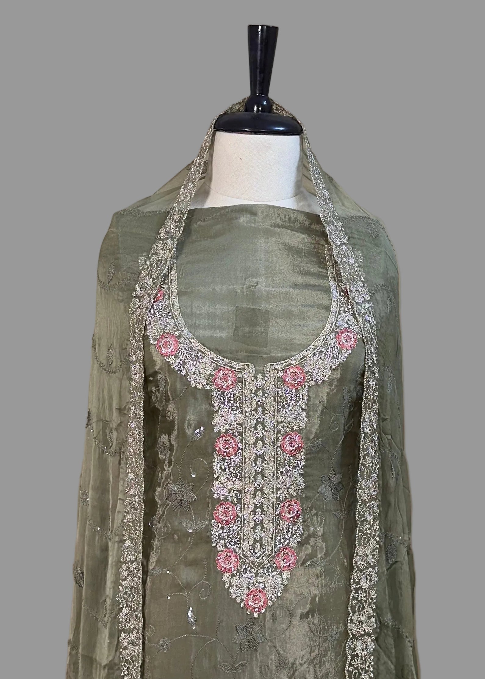Traditional outfit with embroidered top and dupatta on a mannequin against a plain background