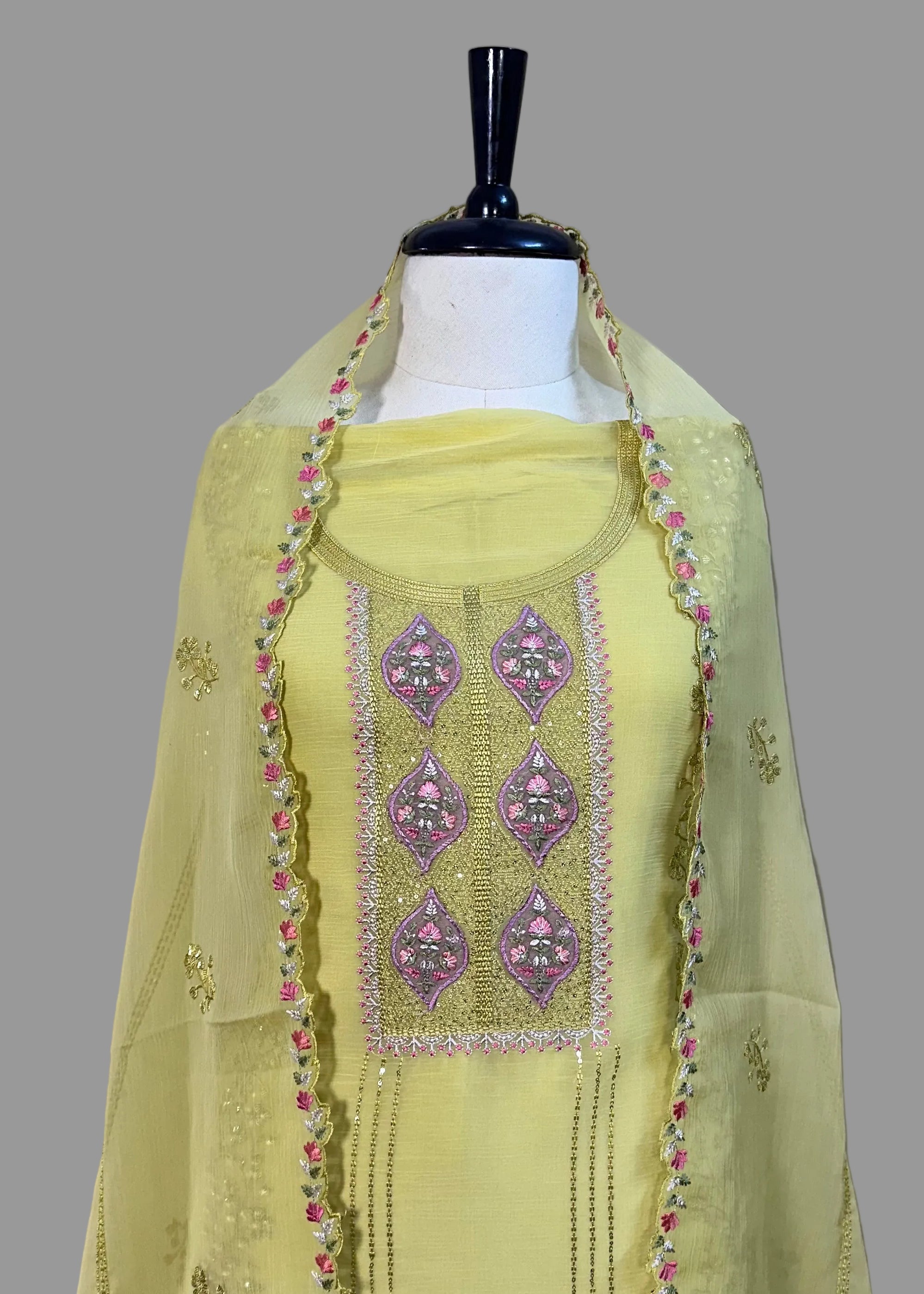 Light green embroidered dupatta on a mannequin against a plain background