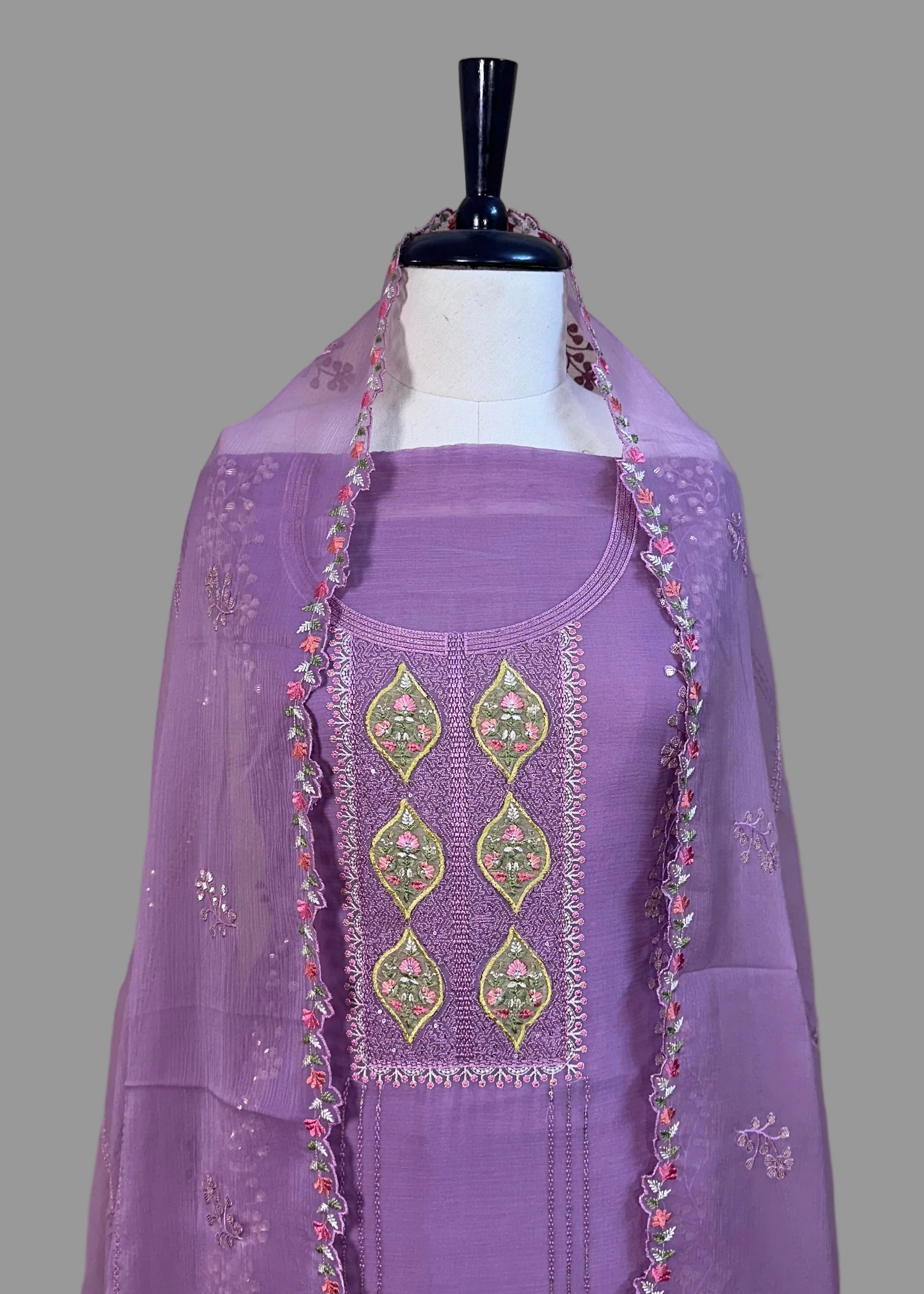 Purple outfit with embroidered dupatta on a mannequin against a plain background