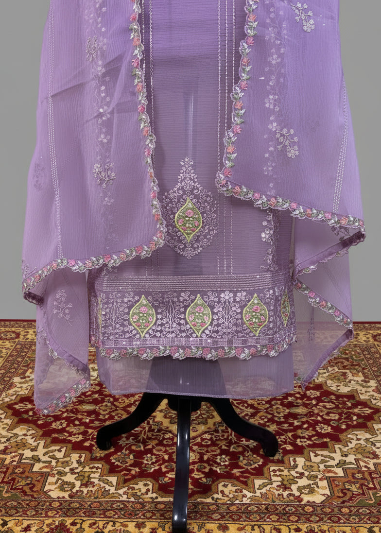Lavender embroidered traditional outfit on a mannequin against a patterned rug.
