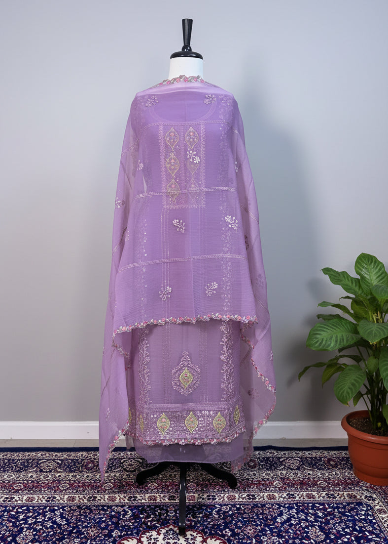 Lavender embroidered traditional outfit on a mannequin against a white curtain background.
