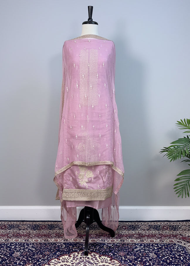 Pink dress on a mannequin against a plain background