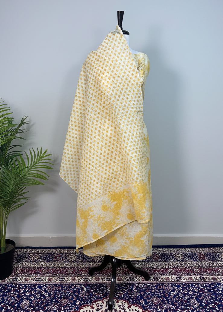 Mannequin wearing a yellow floral dress against a plain background