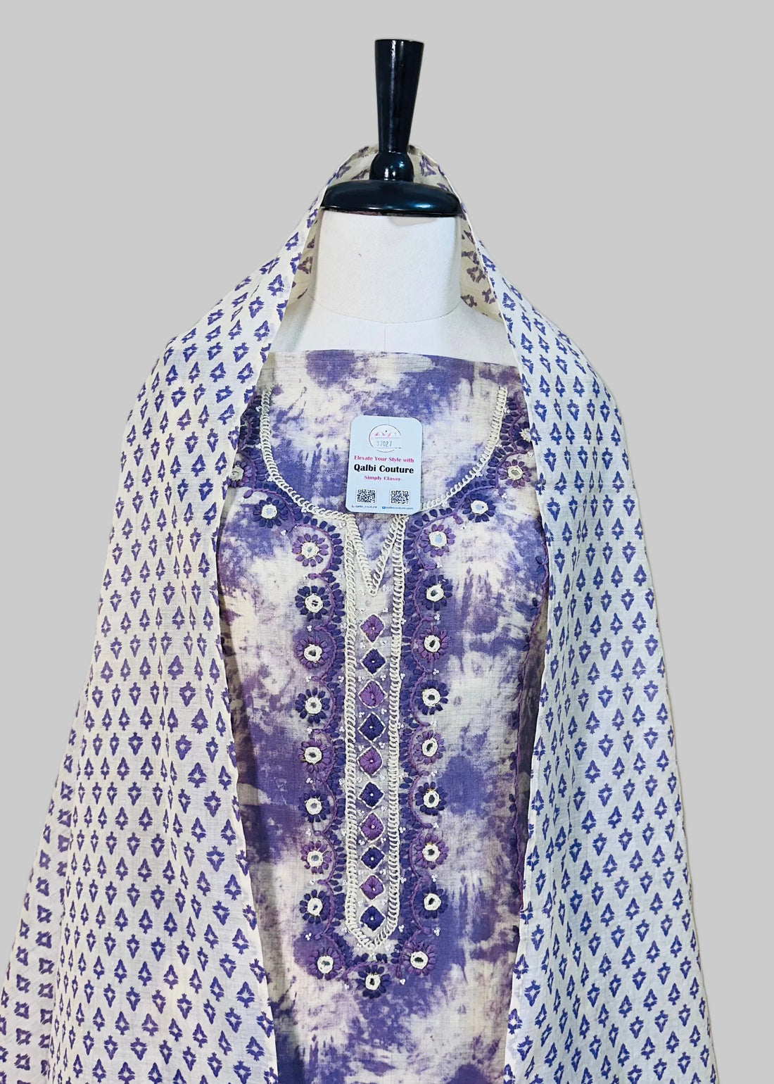 Mannequin wearing a floral dress with a white background