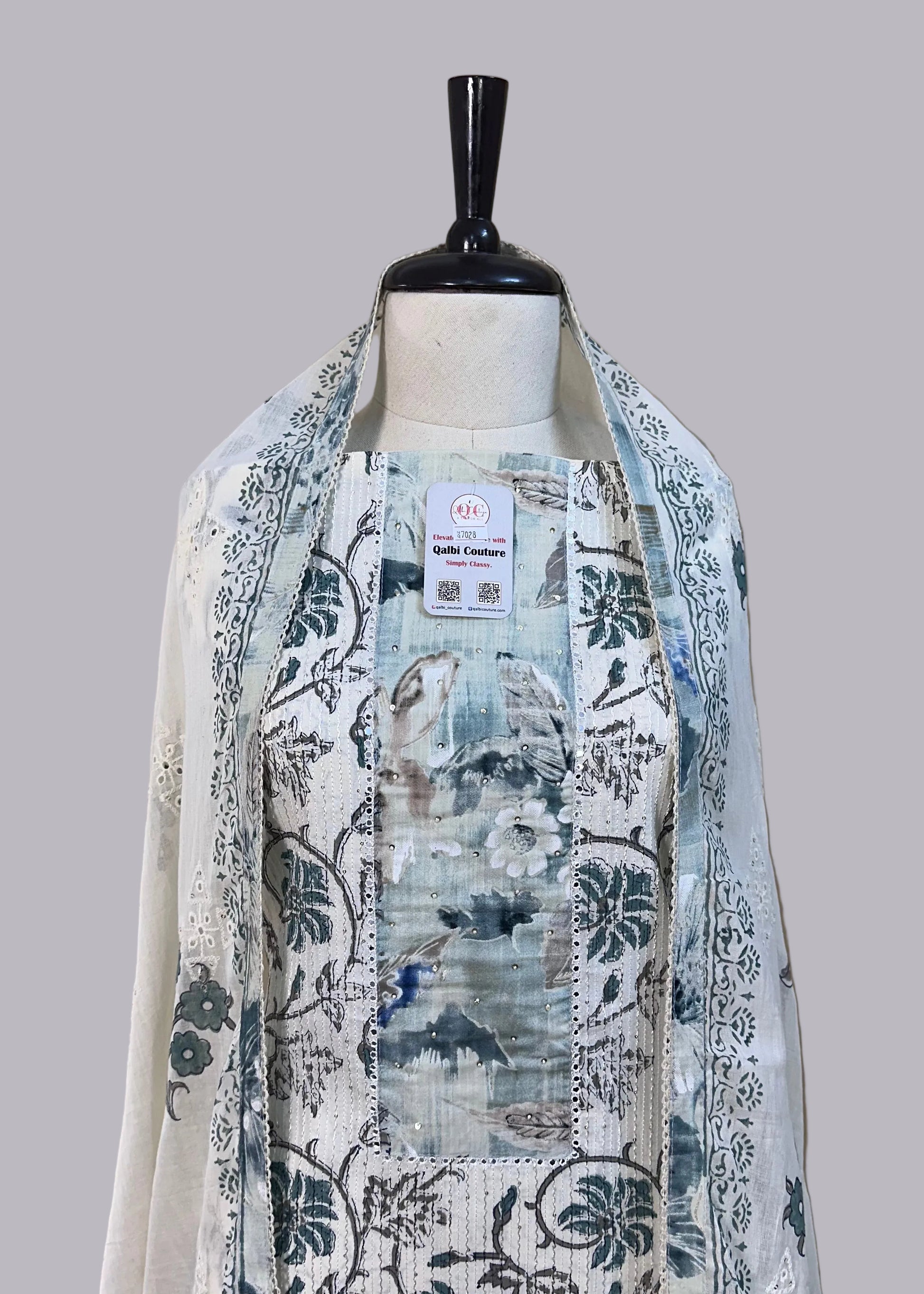 Mannequin wearing a floral-patterned scarf with a beige background