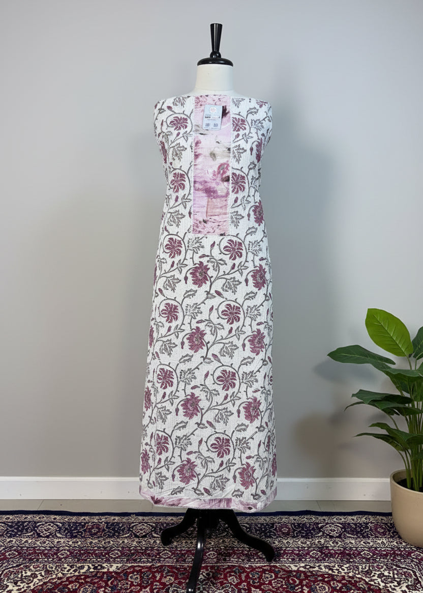 Floral dress on a mannequin against a beige curtain background