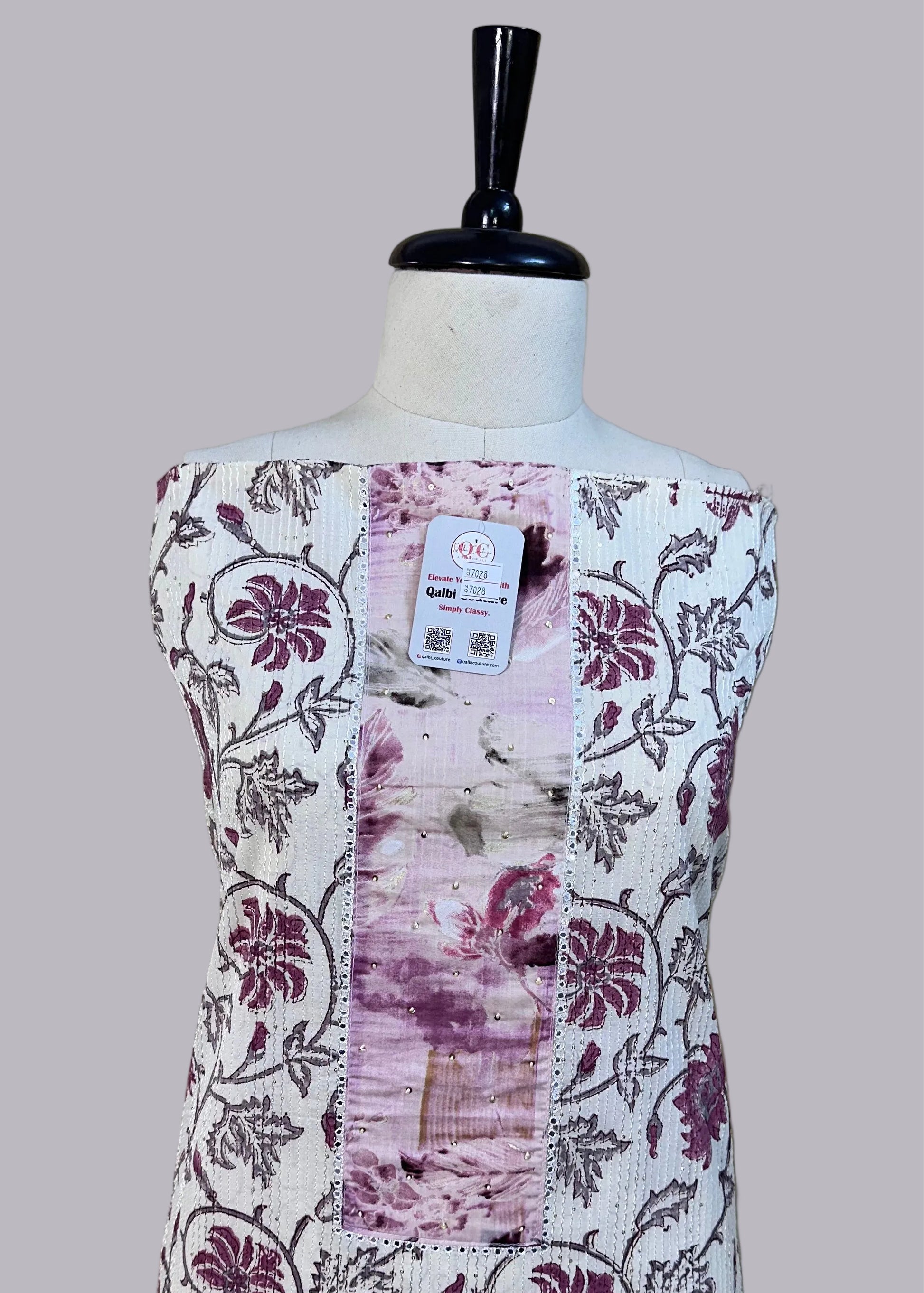 Mannequin wearing a floral dress with a beige background