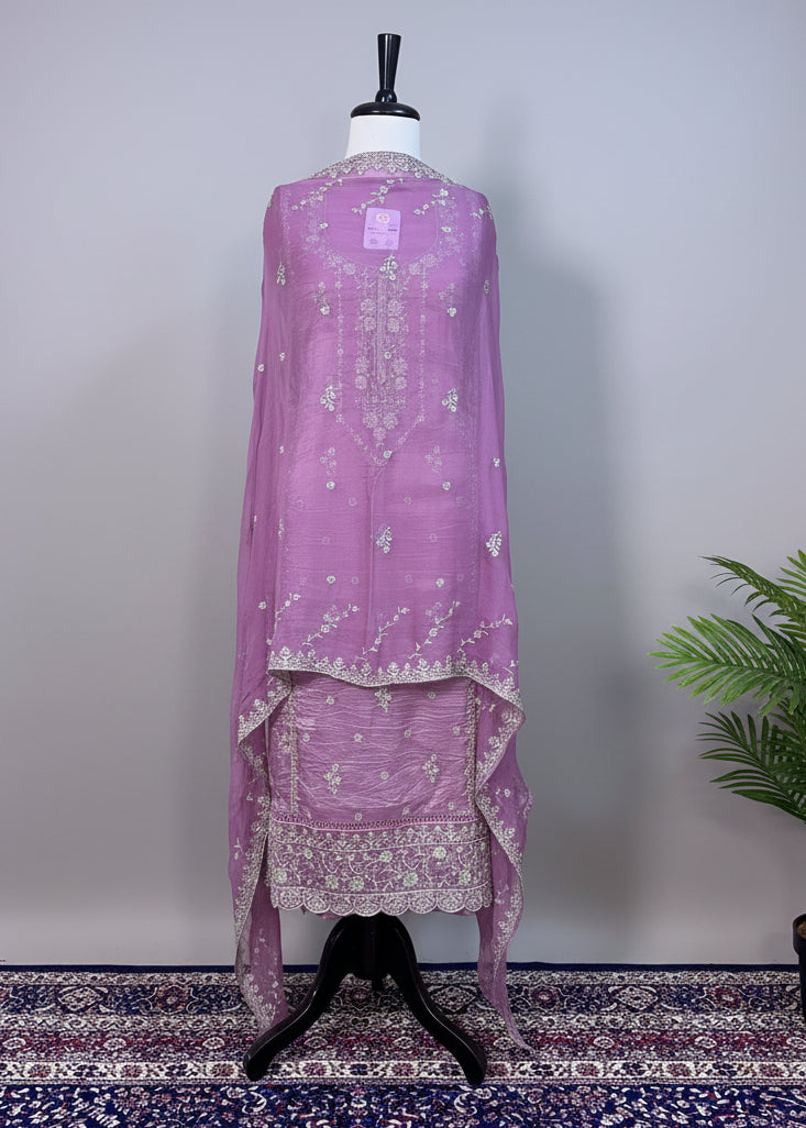 Lavender embroidered traditional outfit on a mannequin against a plain background