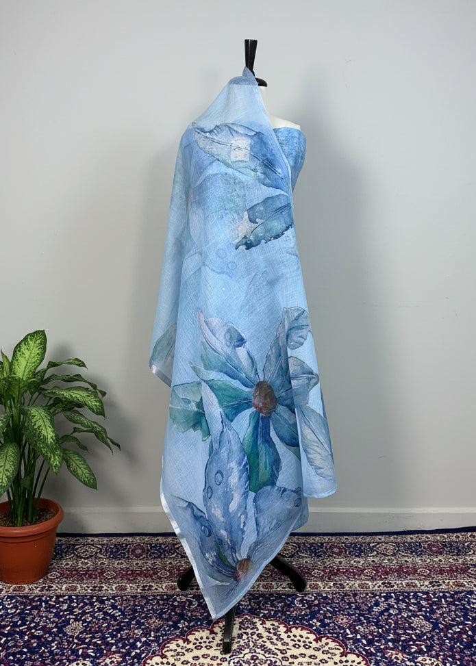Mannequin wearing a blue floral dress against a beige curtain with a patterned rug below.