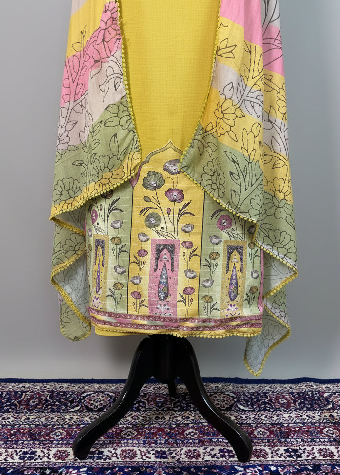 Colorful traditional outfit with a patterned fabric draped over a mannequin on a decorative rug.