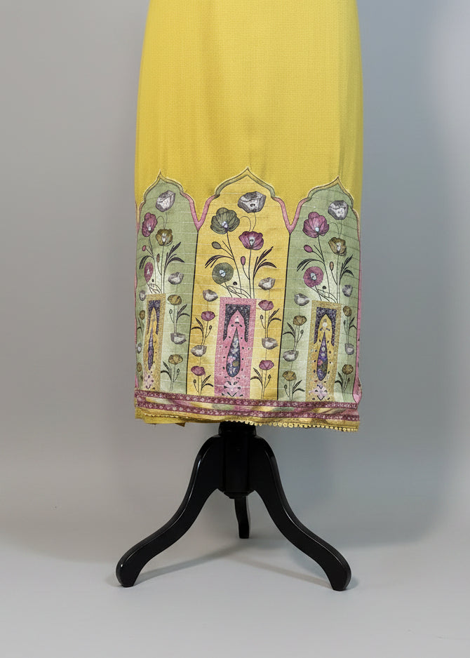 Yellow dress with floral embroidery on a mannequin against a plain background