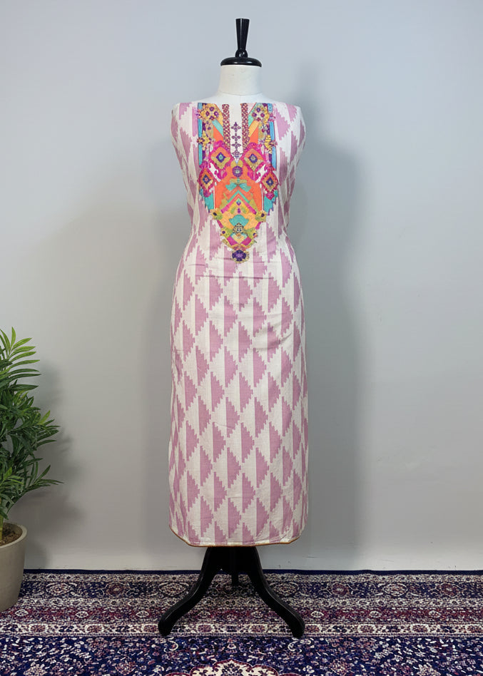 Mannequin wearing a dress with geometric pattern against a beige curtain background